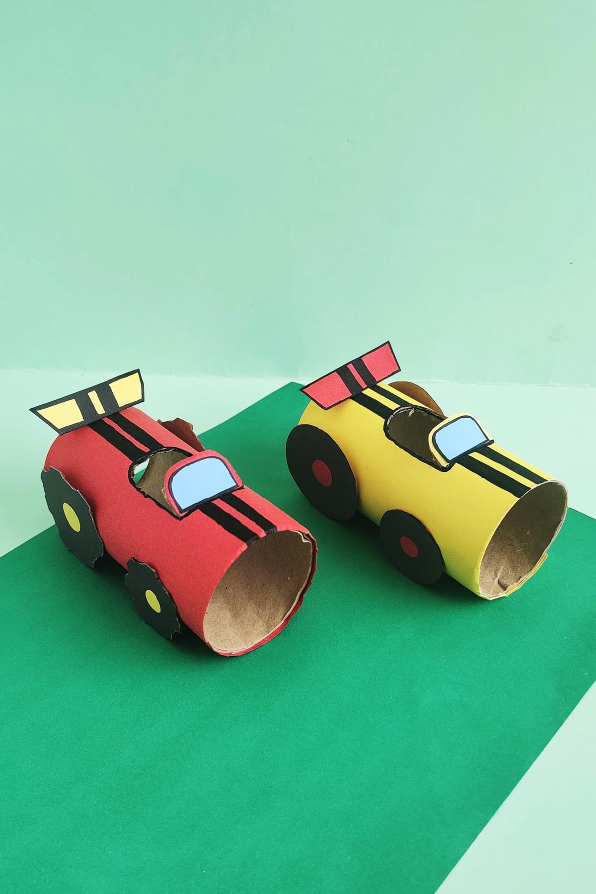 DIY race cars made from basic home-found tools like toilet paper rolls, scissors, markers, and glue