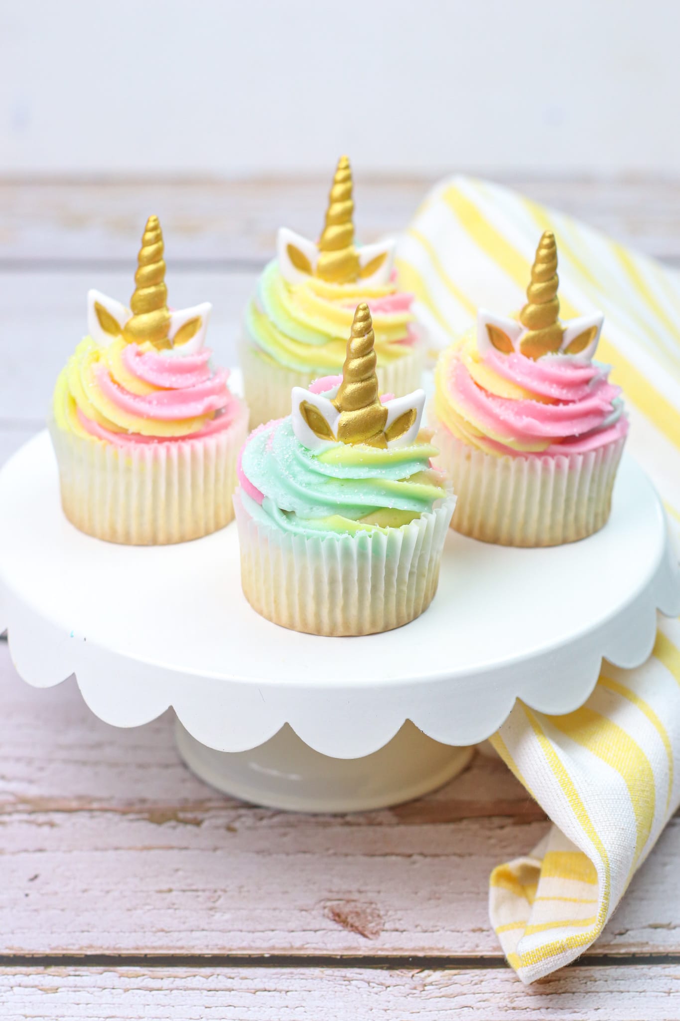 Unicorn cupcakes on white cake stand