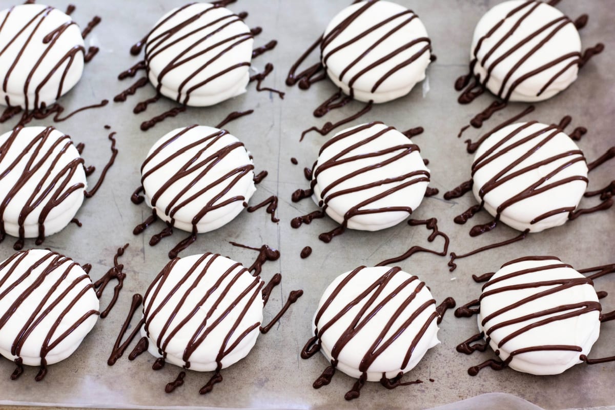 White chocolate covered oreos with chocolate drizzle