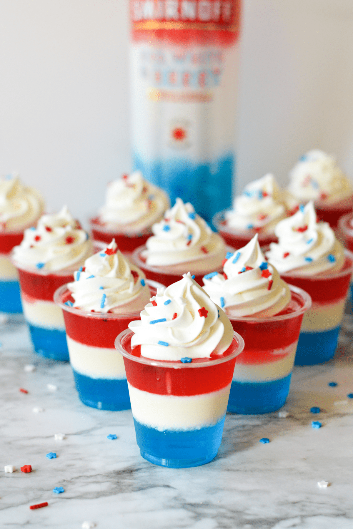 Red, white and blue jello shots with vodka bottle