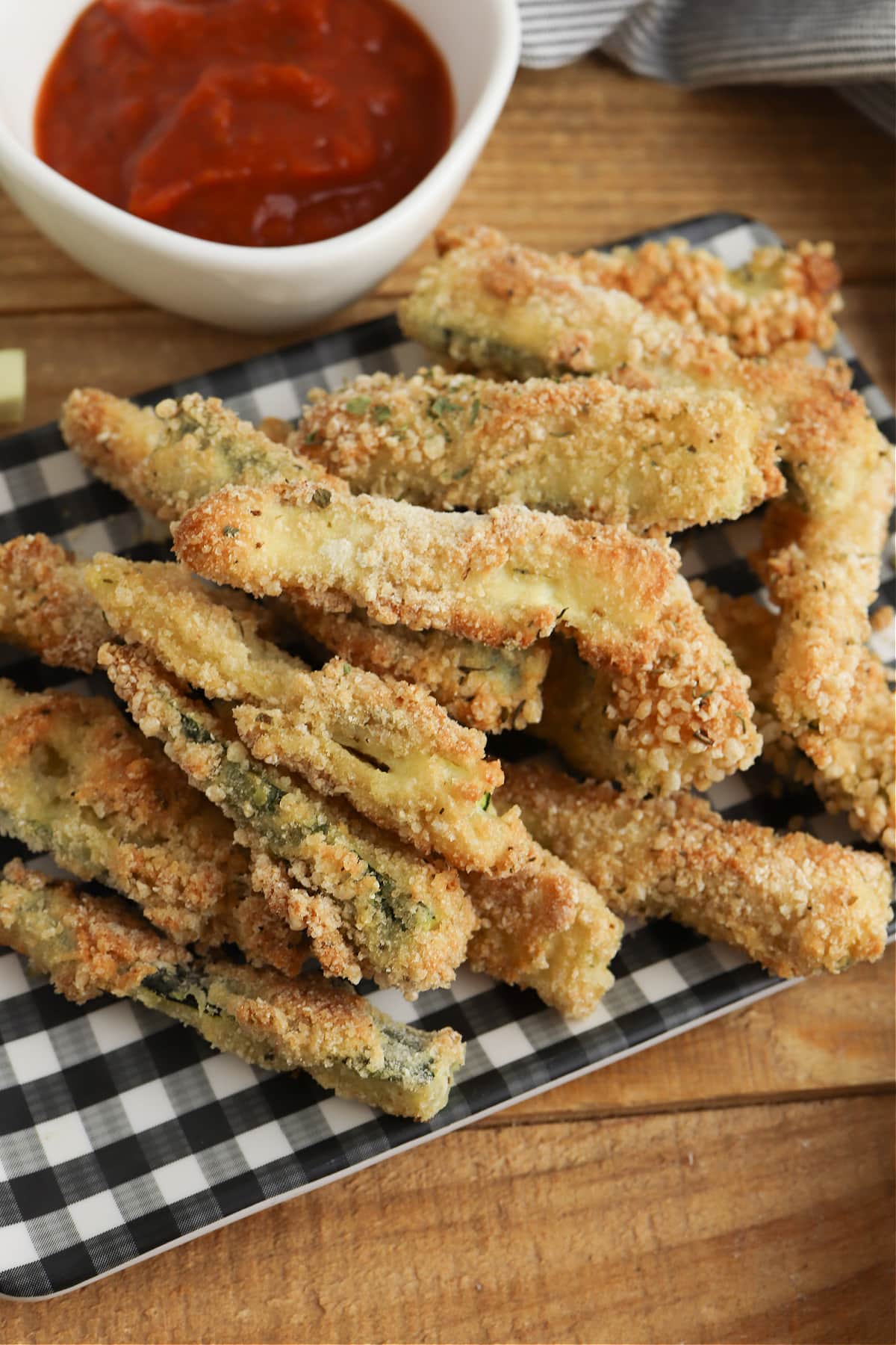 Crispy baked zucchini fries on checkered plate