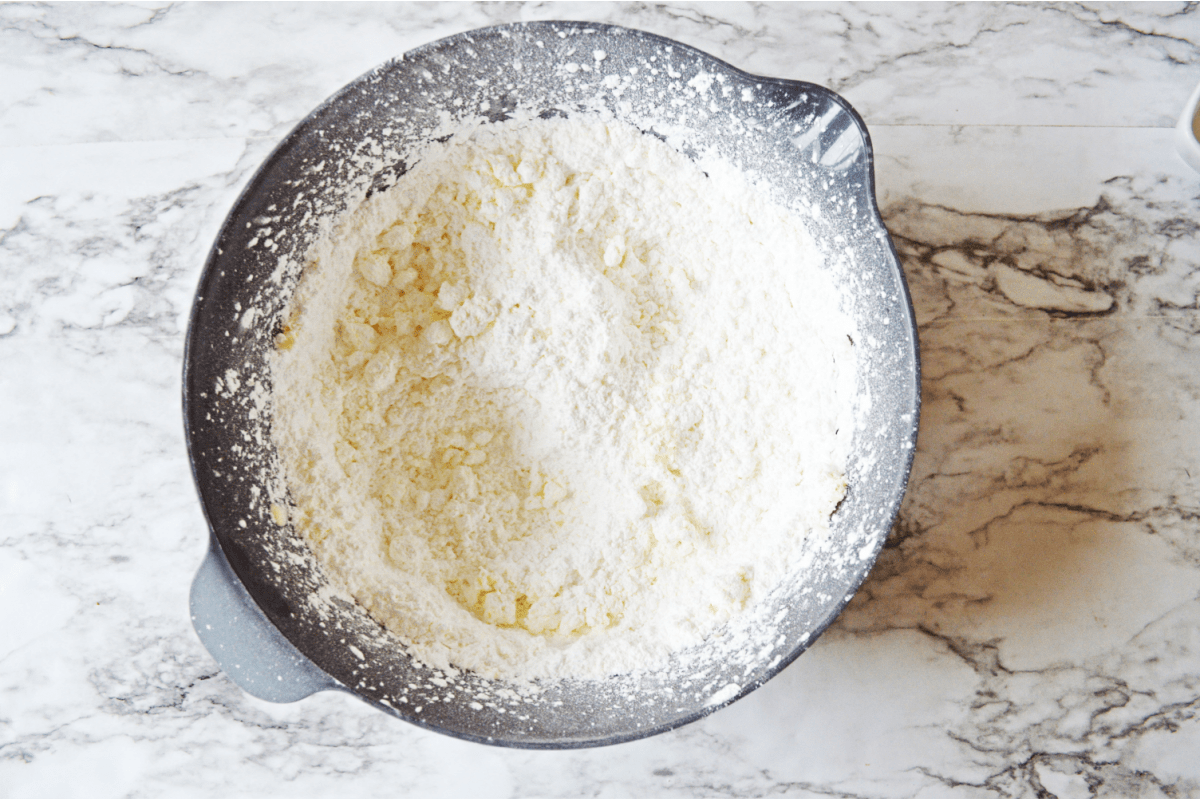 Powdered sugar with butter in mixing bowl