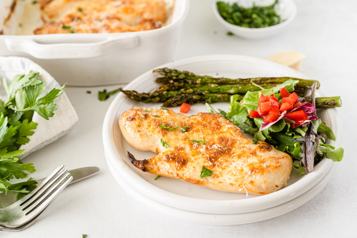 Chicken with salad and asparagus on plate