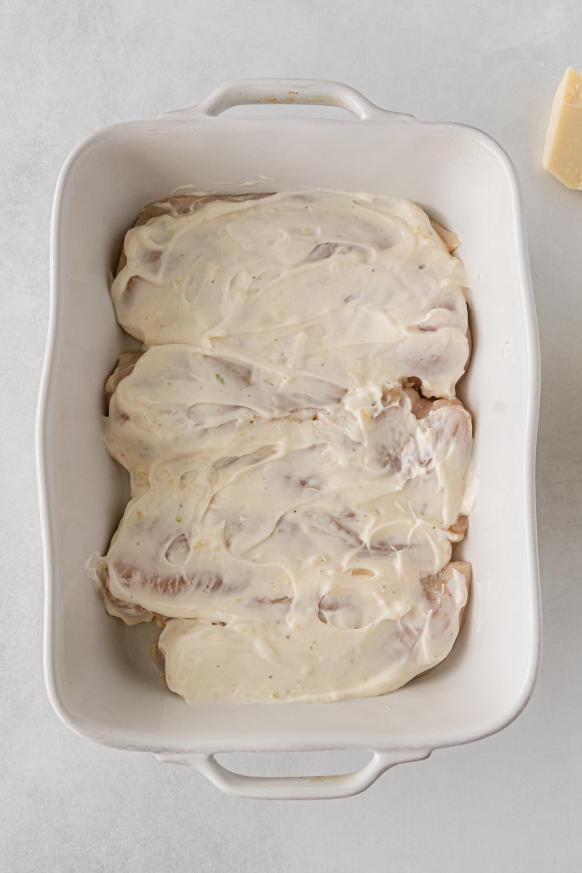 Mayo spread over chicken breasts