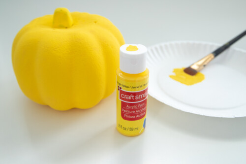 Pumpkin painted with yellow acrylic paint