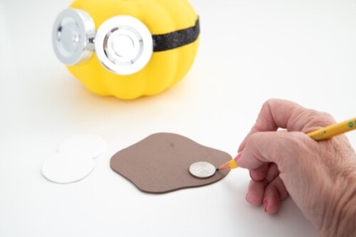 Tracing a coin on brown craft foam