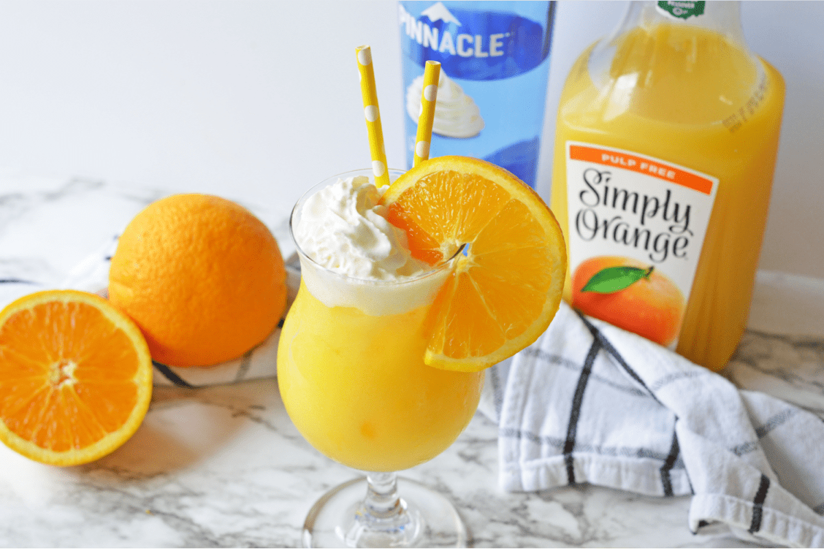 Orange Creamsicle Cocktail with whipped cream and orange slice