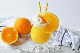 Orange creamsicle drink with black and white napkin
