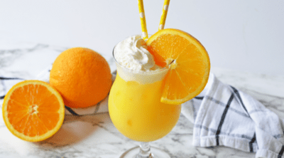 Orange creamsicle drink with black and white napkin