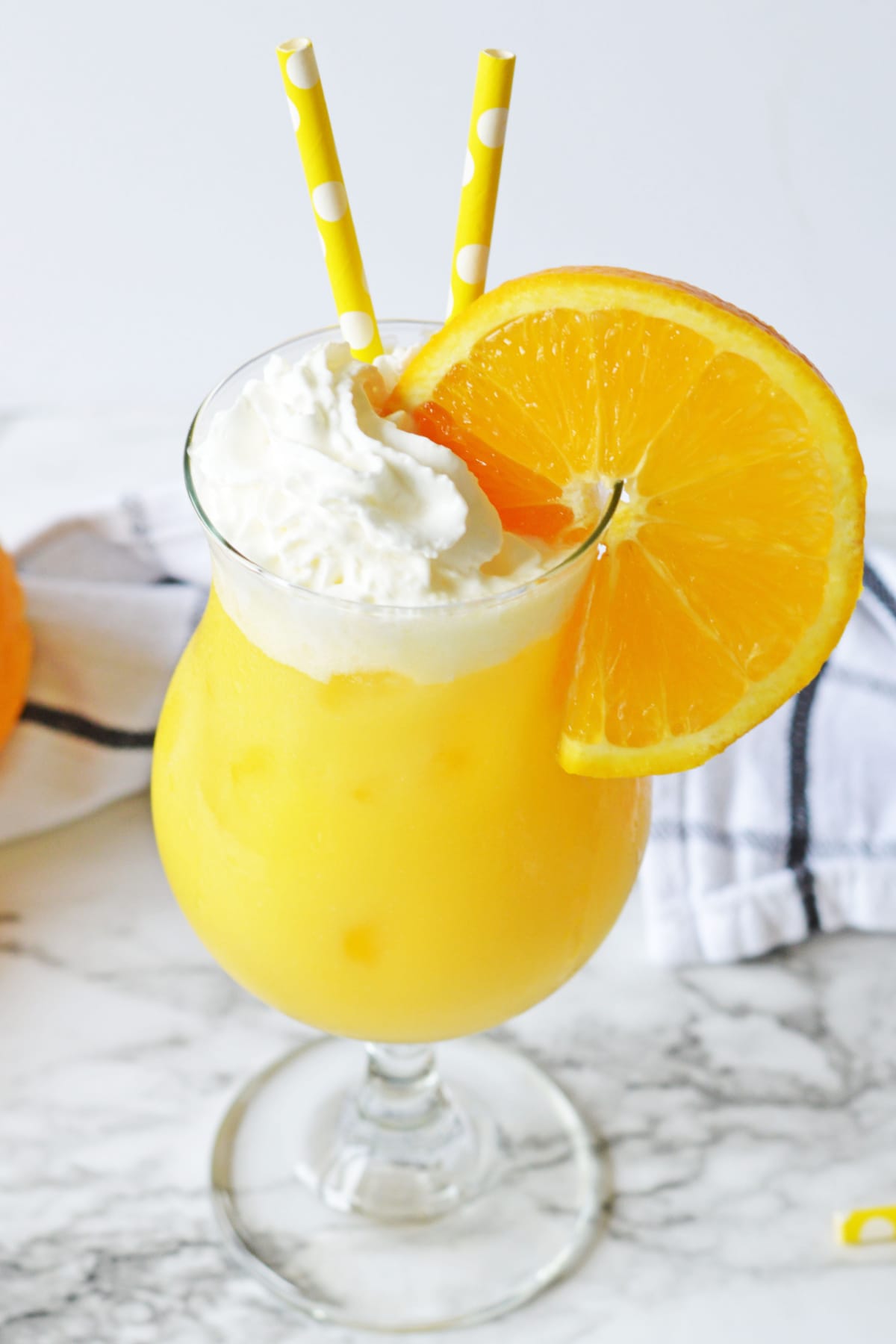 Orange creamsicle cocktail with orange wheel