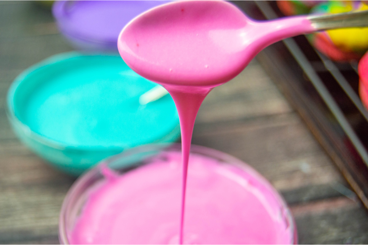 Pink icing on a spoon