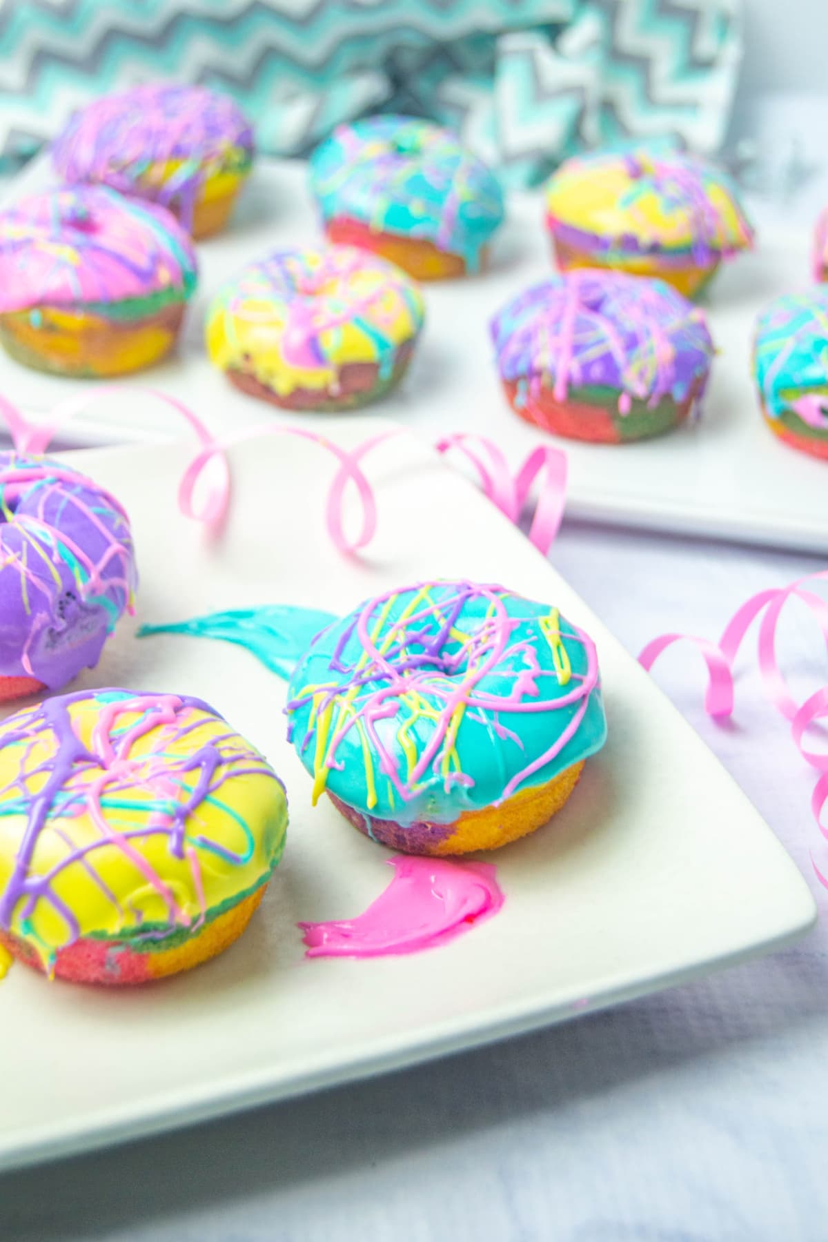 Colorful donuts on white plate