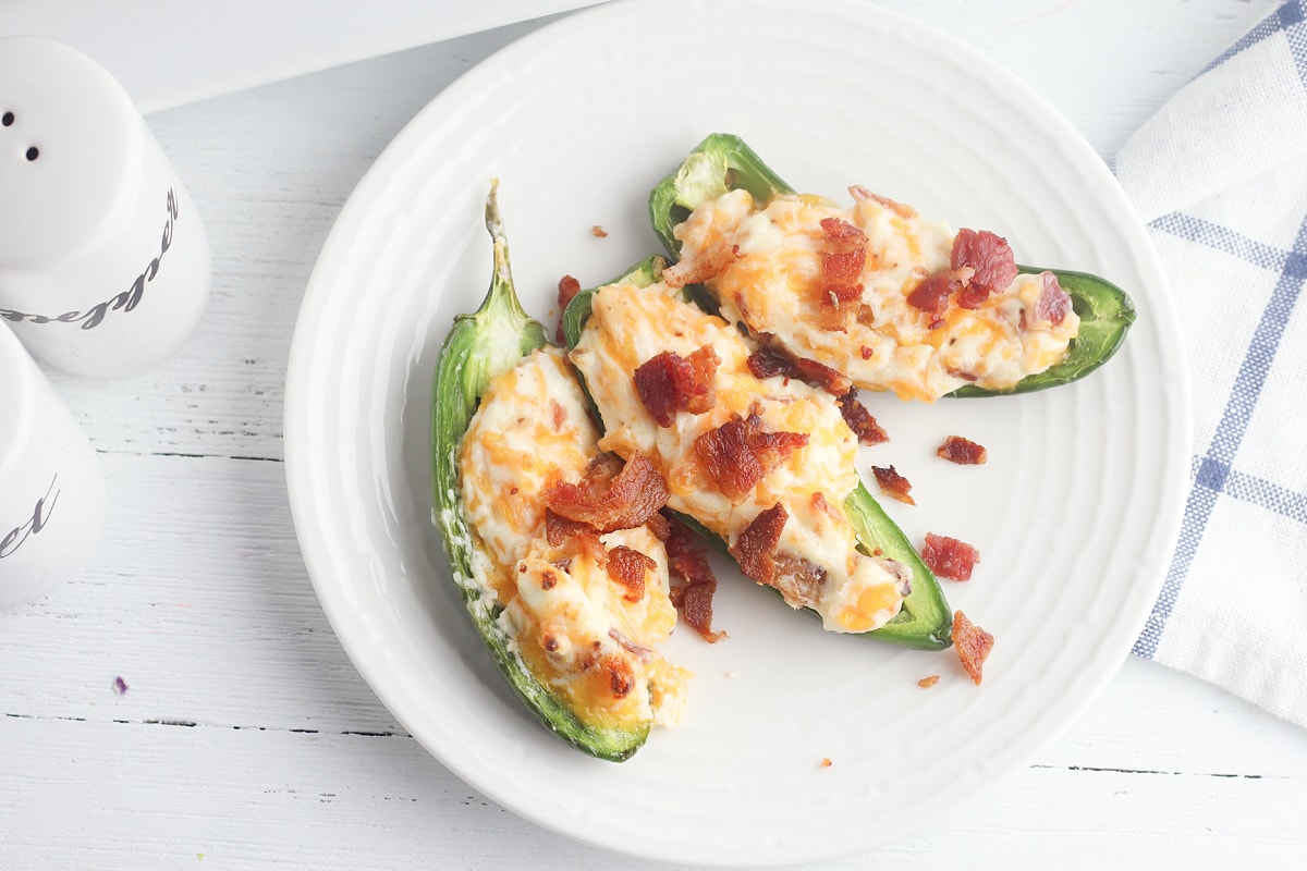Baked jalapeno poppers with bacon on wooden table