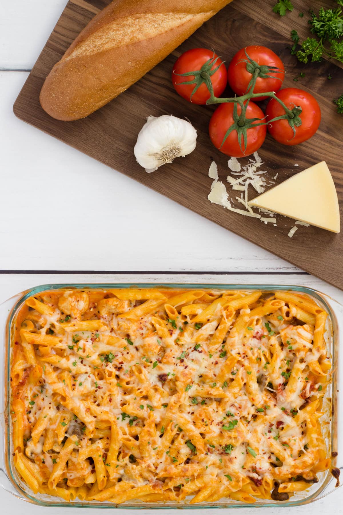 Chicken pasta casserole with ingredients and bread