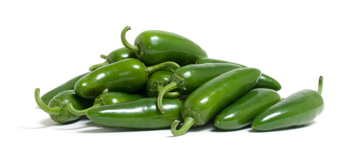 A pile of green jalapenos on a white background 