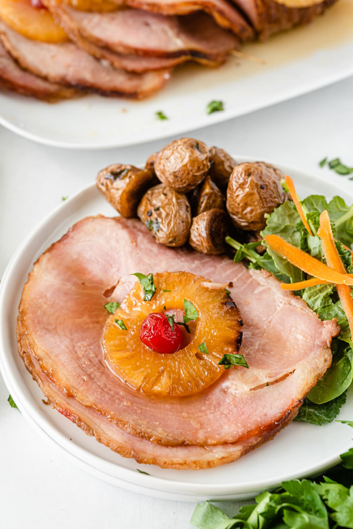 Ham Roast With Brown Sugar Glaze on plate with salad and potatoes