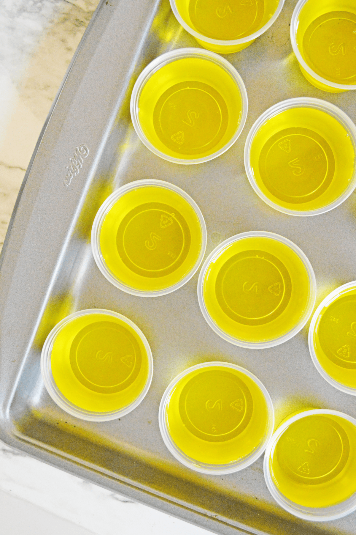 Plastic cups with jello on baking sheet
