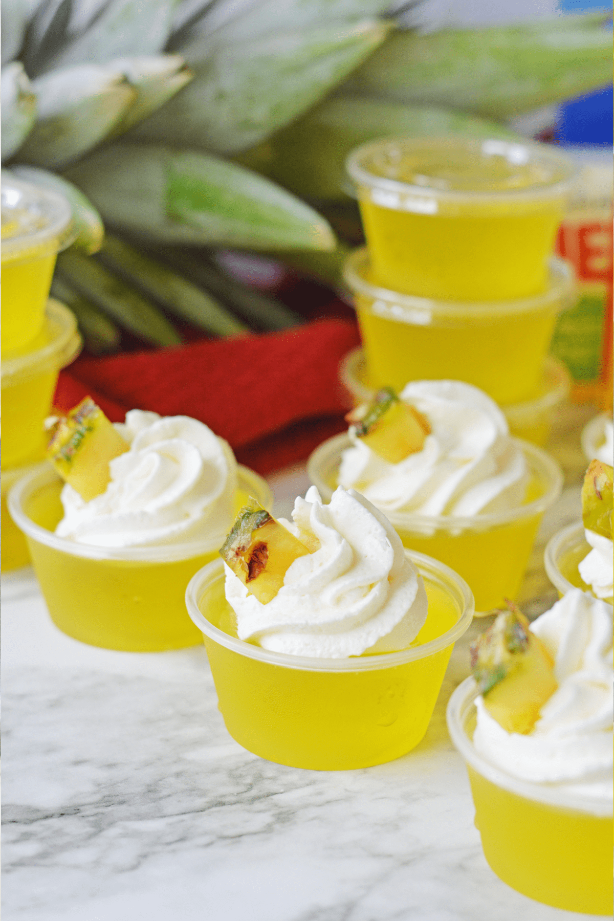 Pineapple jello shots in plastic jello cups