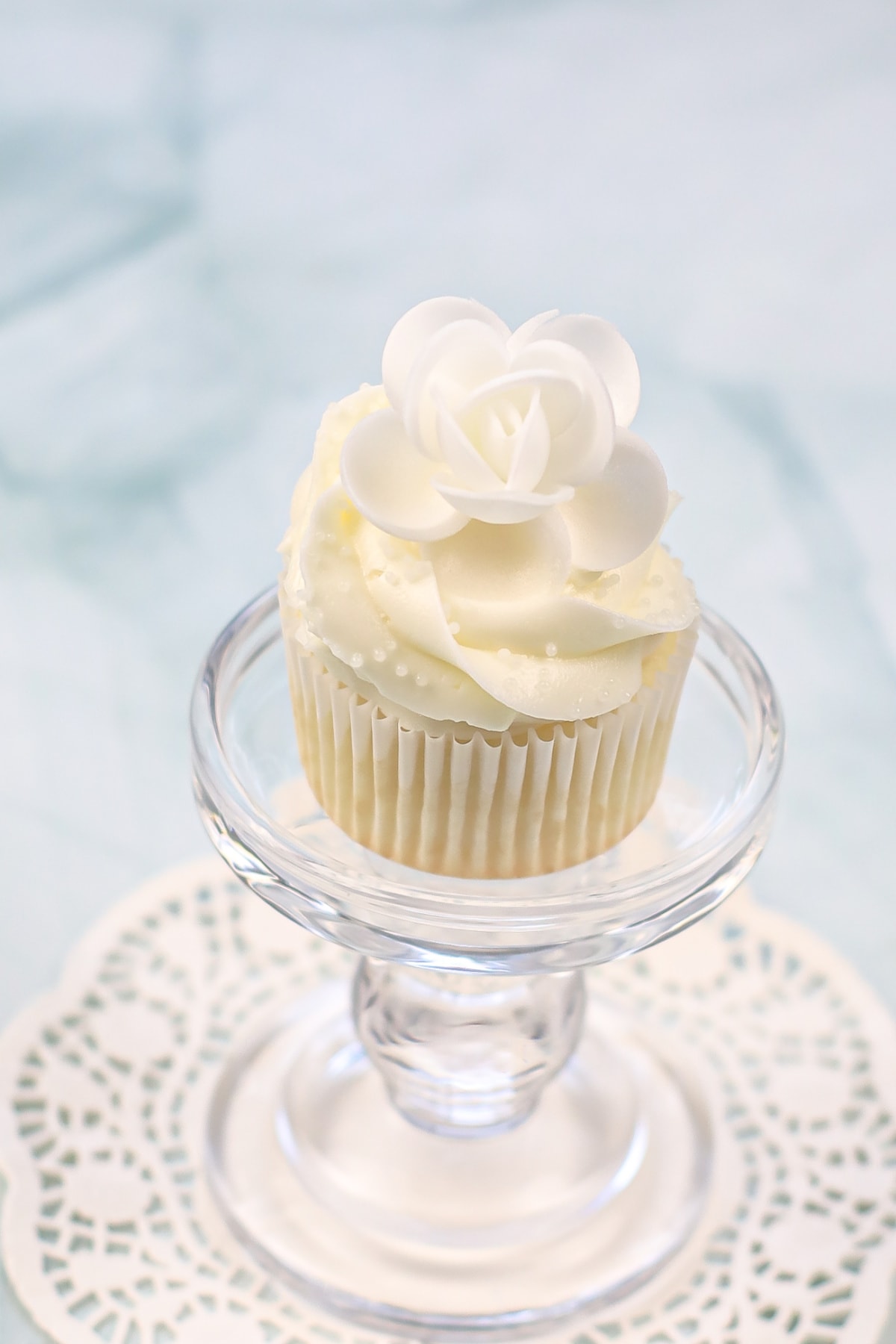 White cupcake on pedestal