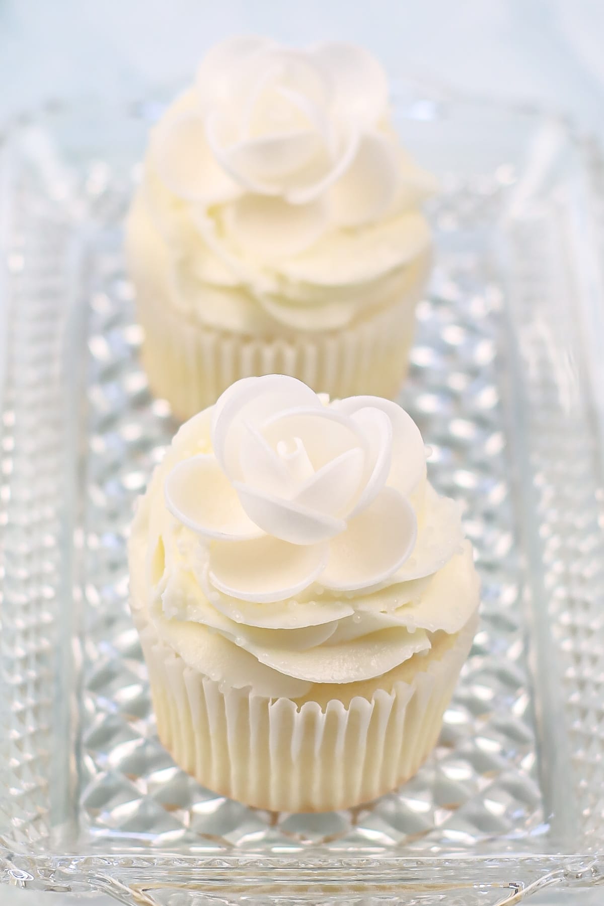 White cupcakes on glass platter