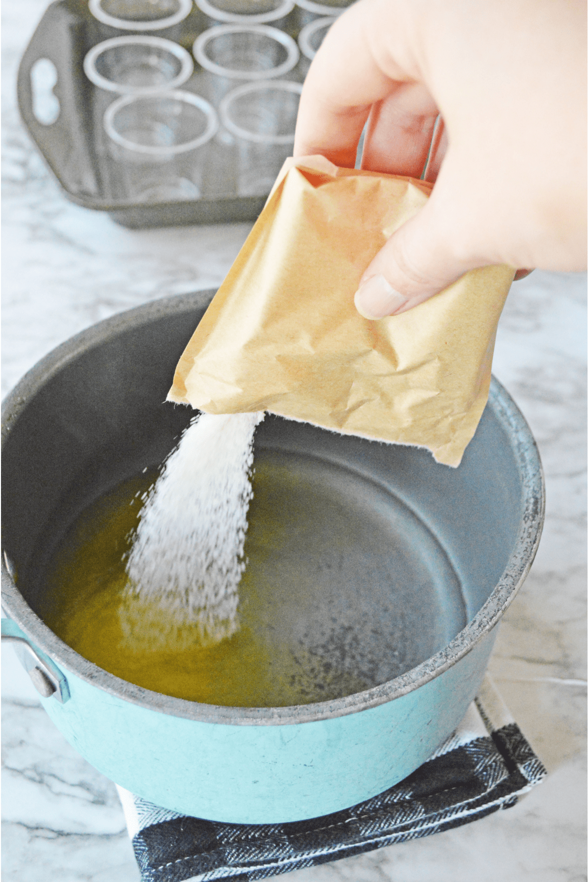 Pouring lemon jello into saucepan with water