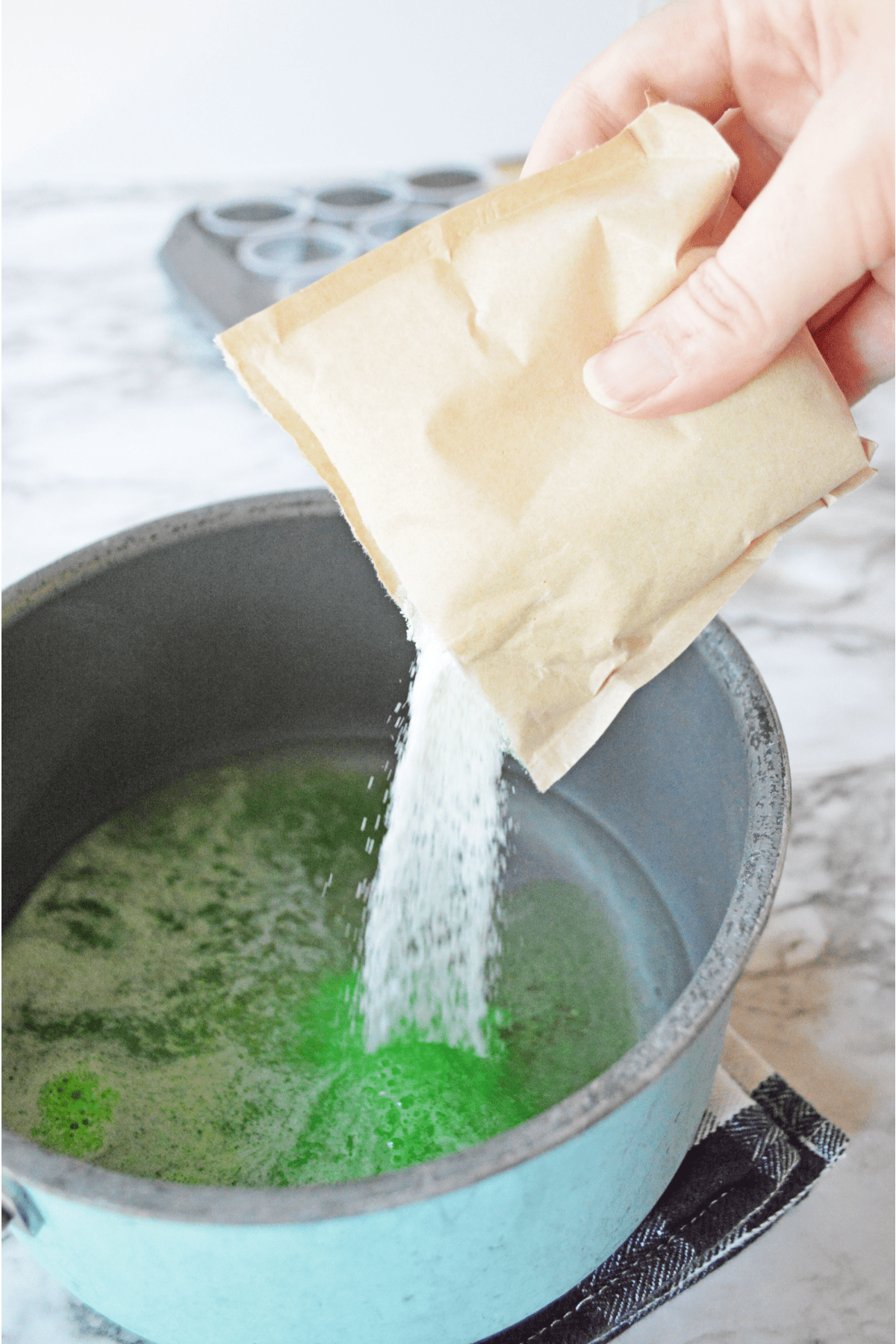 Pouring jello powder into saucepan