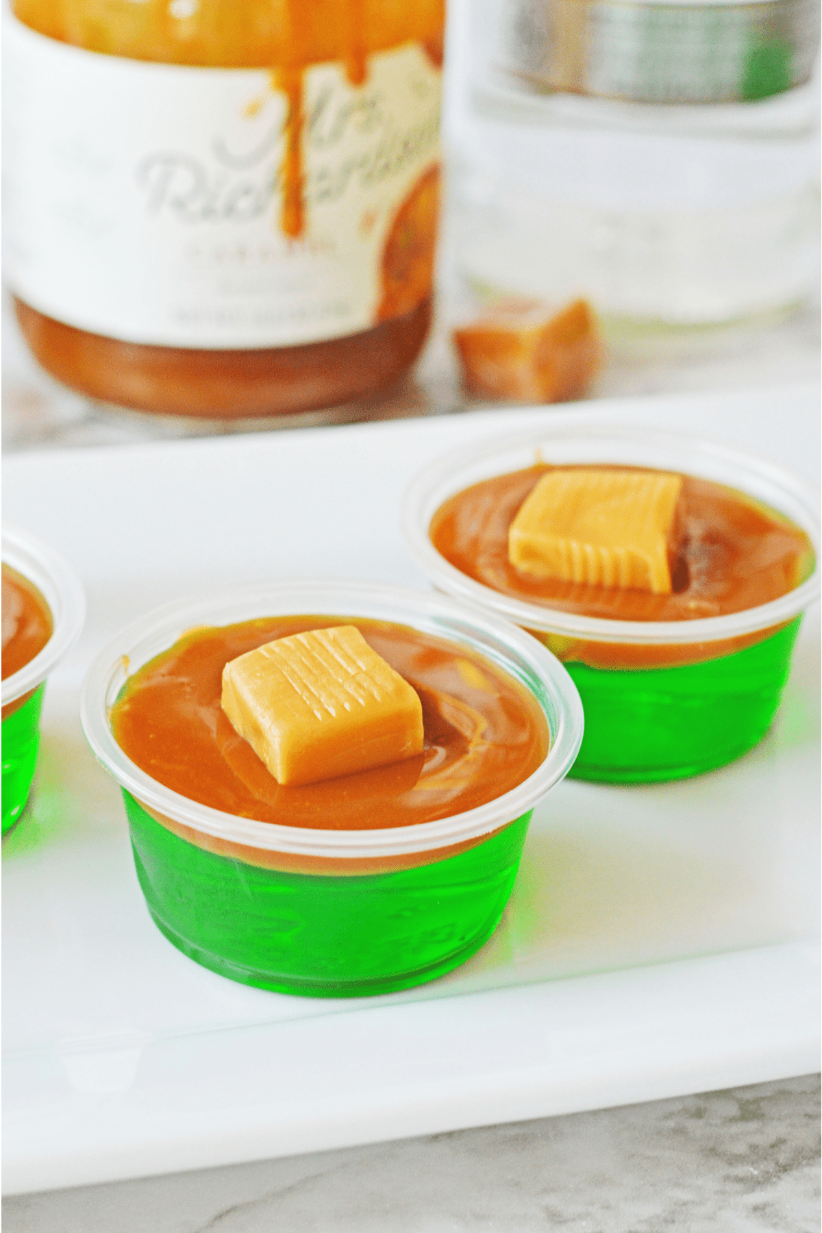 Caramel apple jello shots with caramel in background