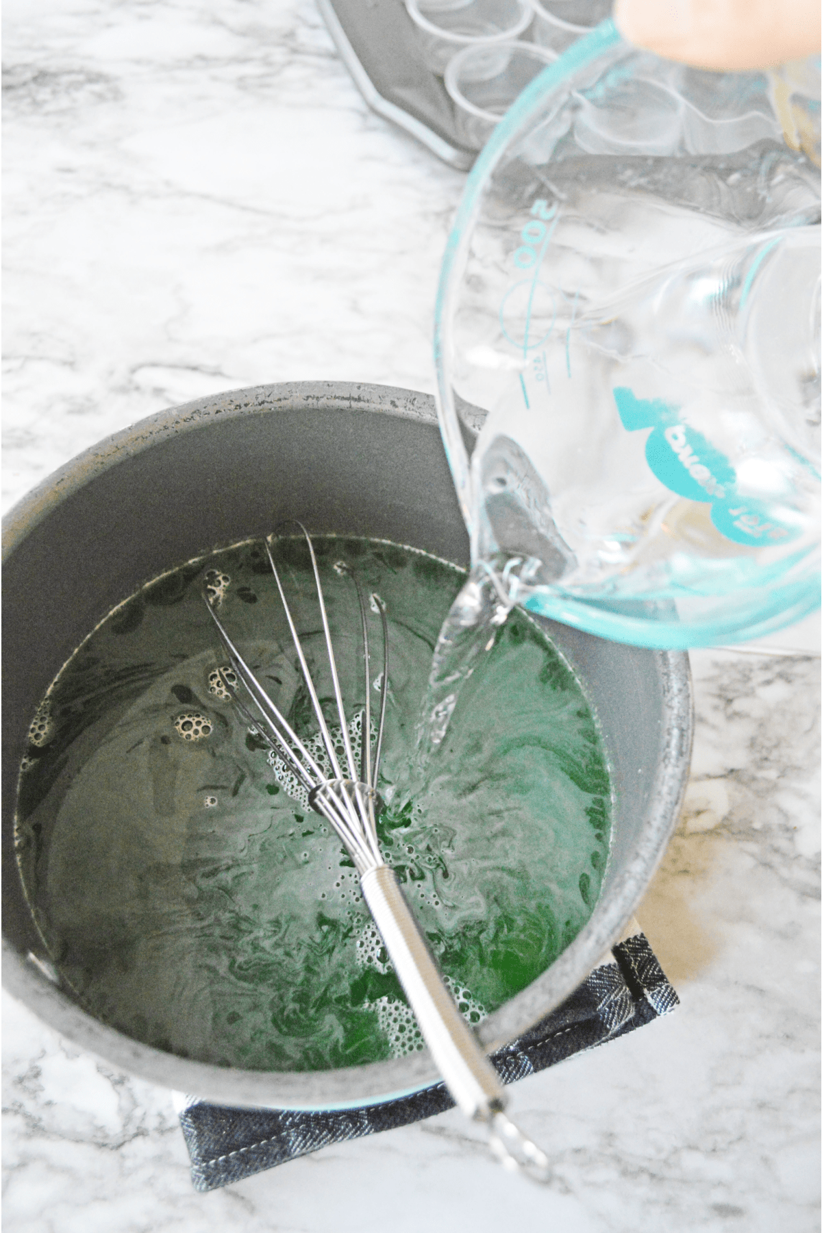 Pouring vodka into saucepan