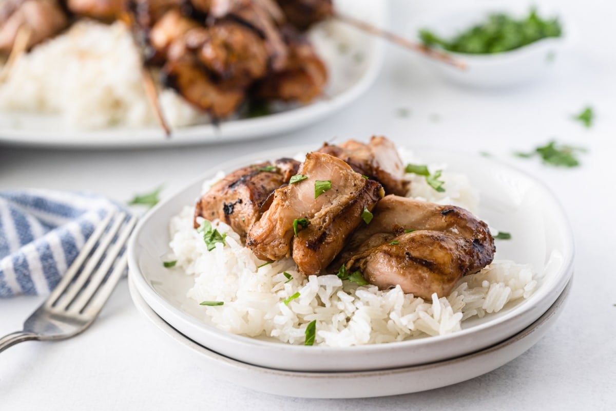 White plate with chinese chicken over white rice