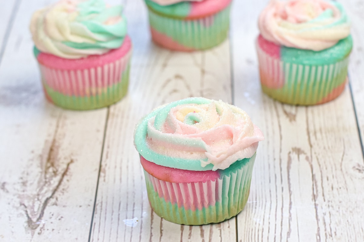 Cotton candy cupcake on wooden table