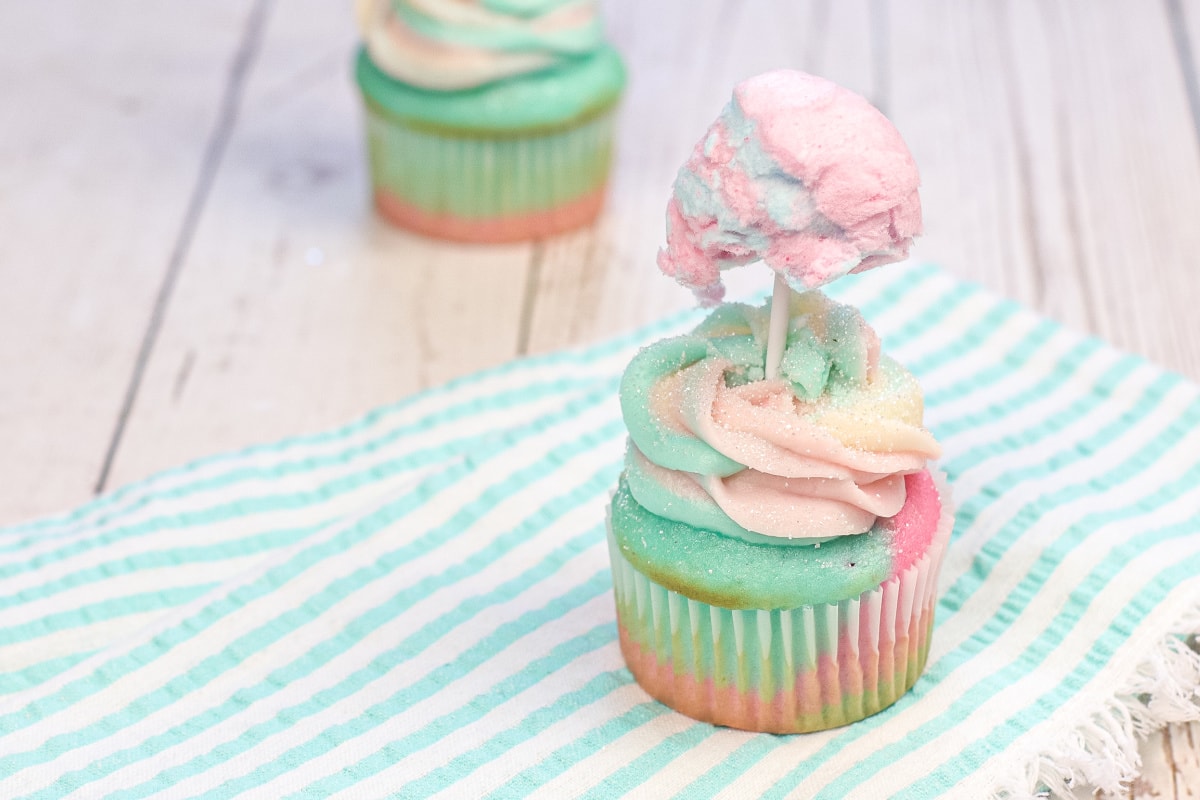 Cotton candy cupcake with cotton candy on stick