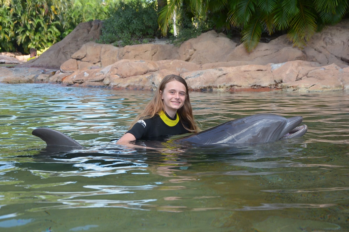 Girl posing with dolphin