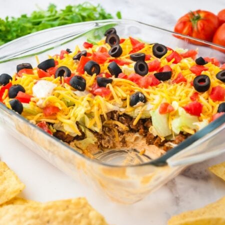 Ground beef taco dip with some scooped out