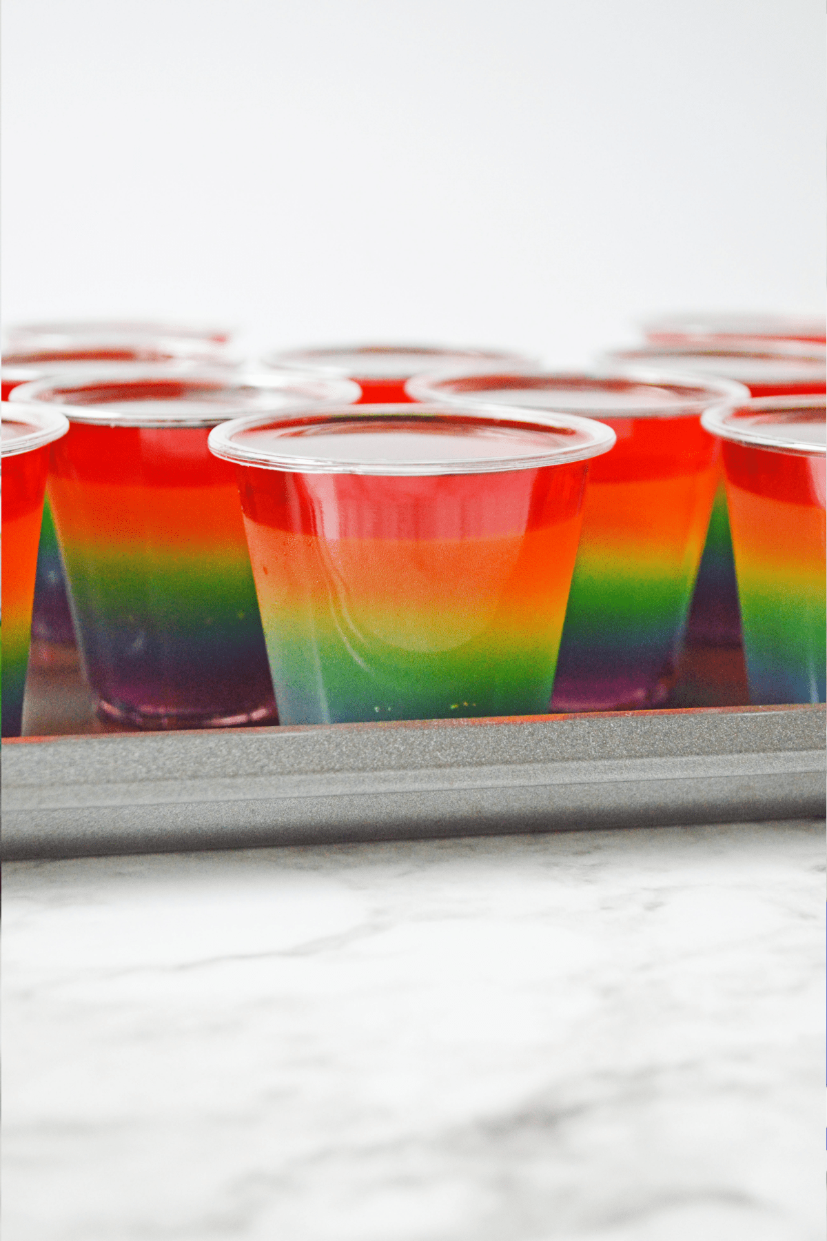 Rainbow jello shots on baking sheet