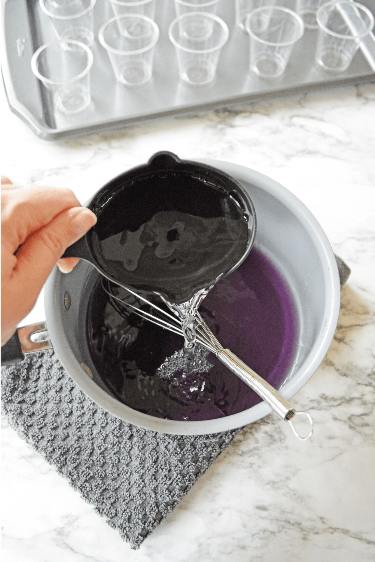 Adding cold water to purple jello mix