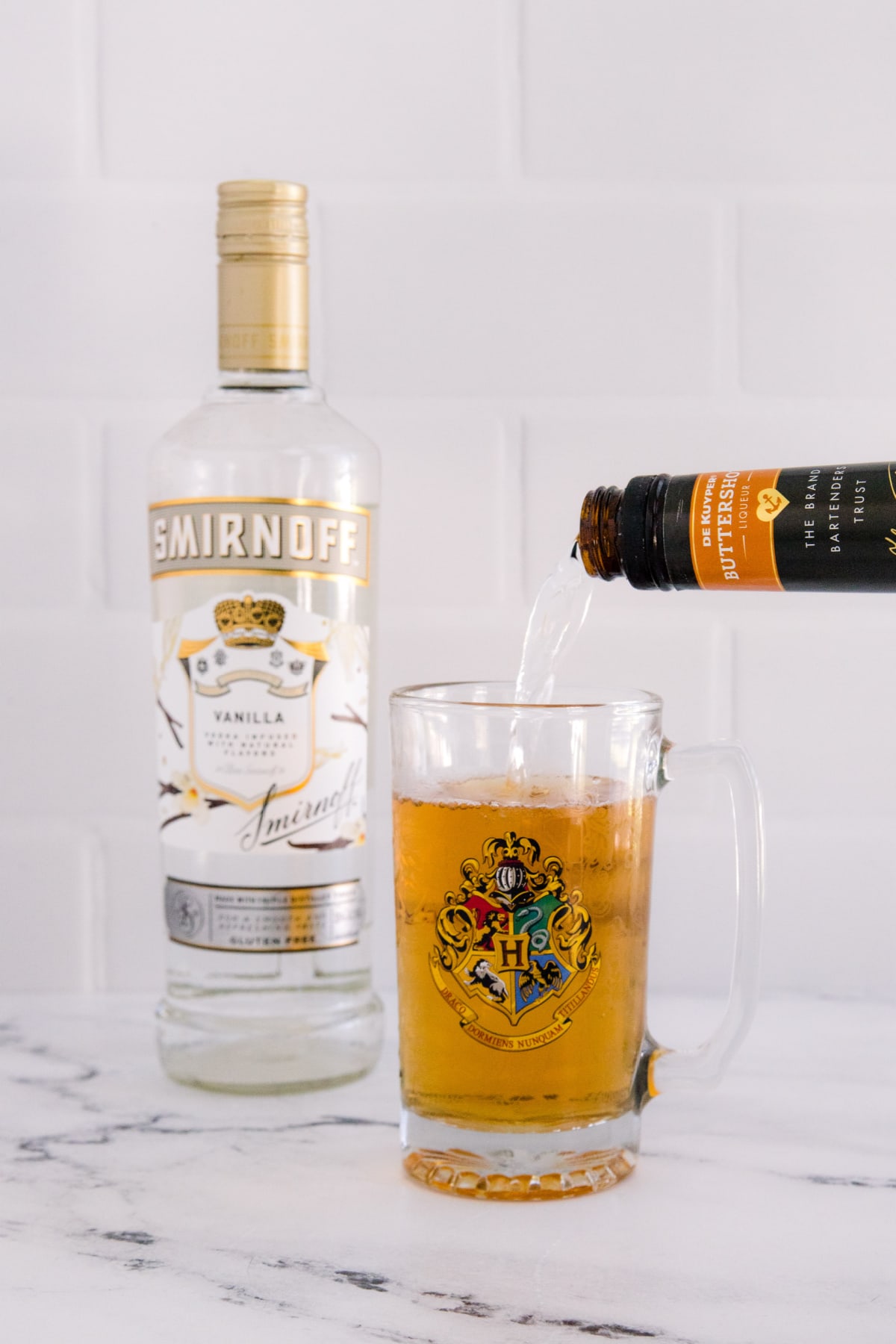 Pouring butterscotch schnapps for boozy butterbeer
