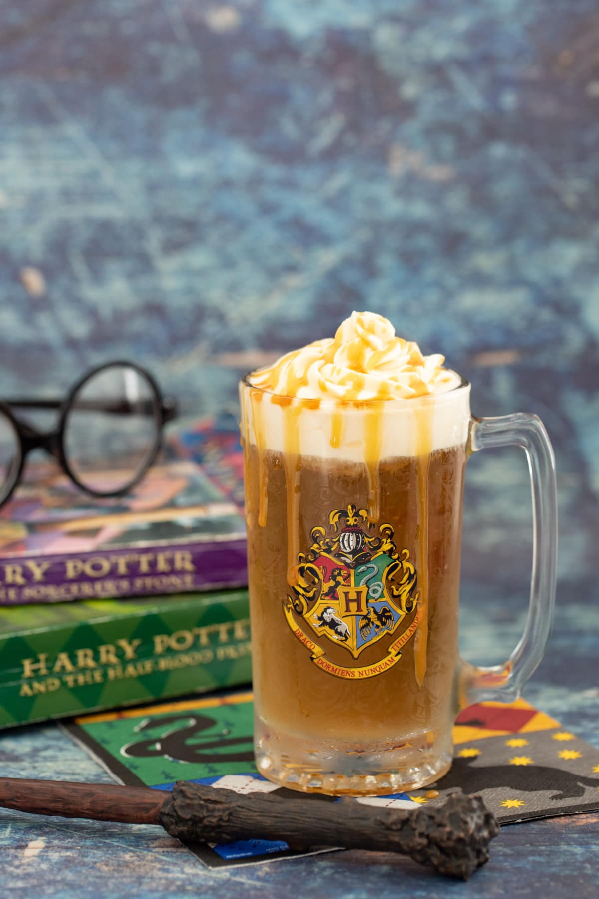 Boozy butterbeer with wand, glasses and books