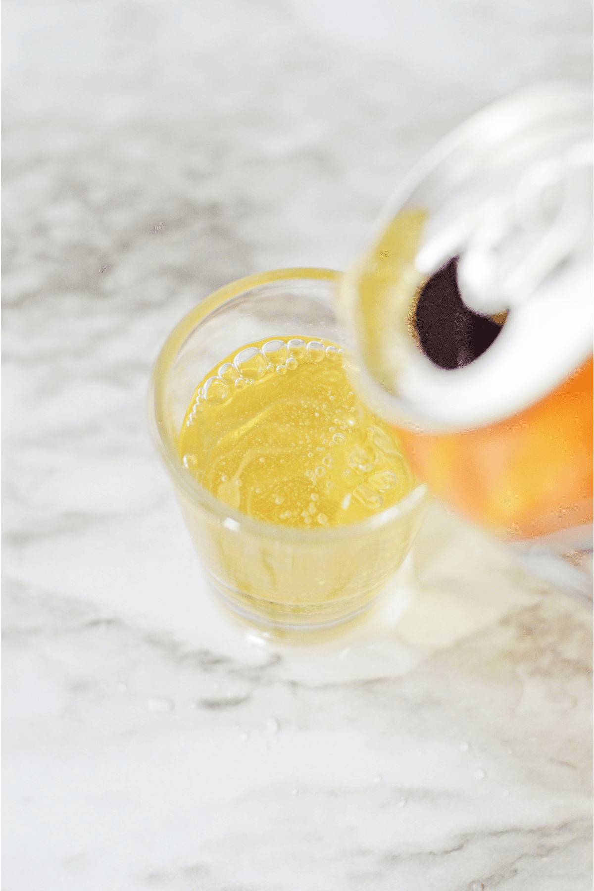 Adding cream soda to shot glass