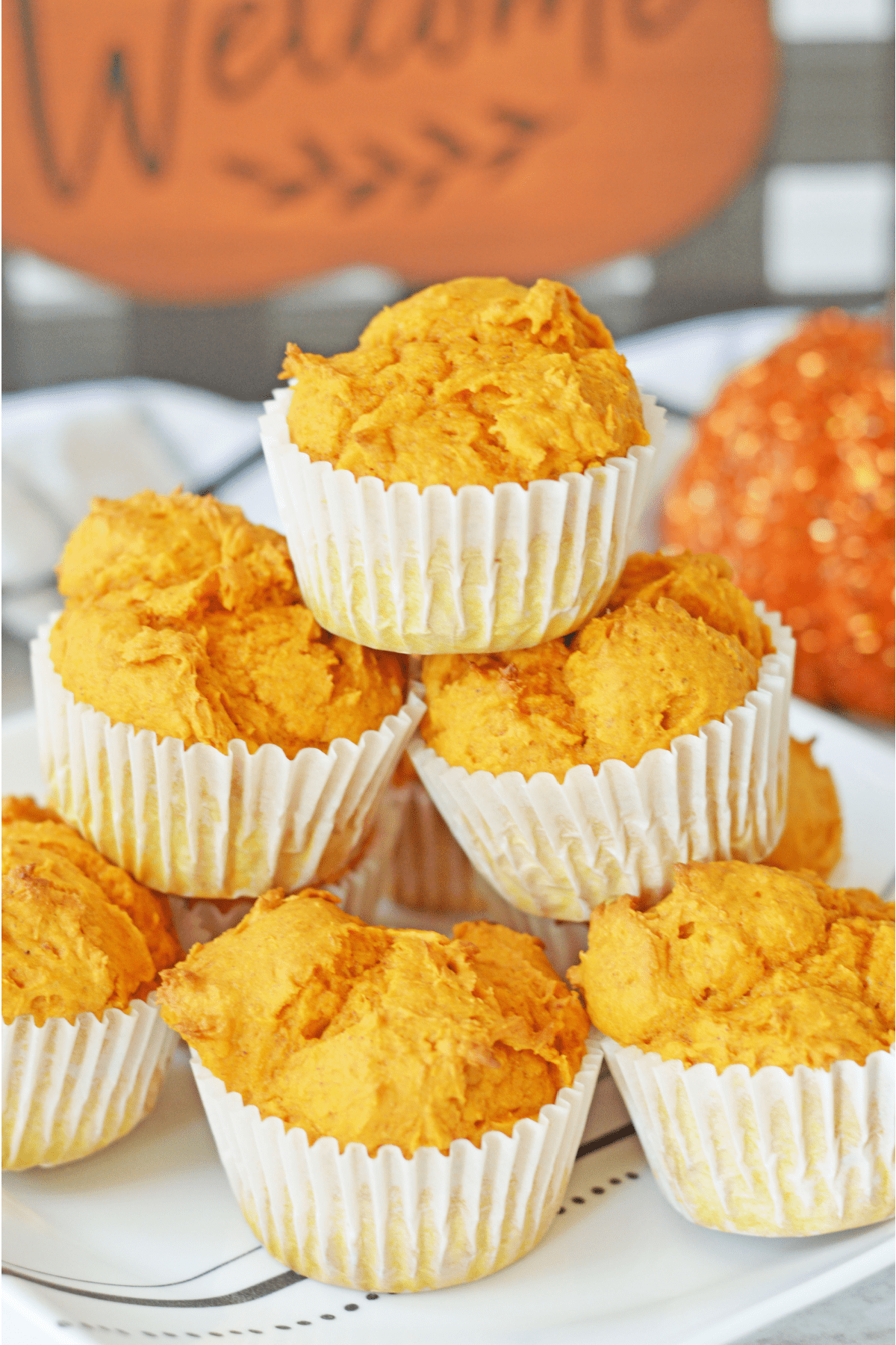 Pumpkin muffins stacked on plate