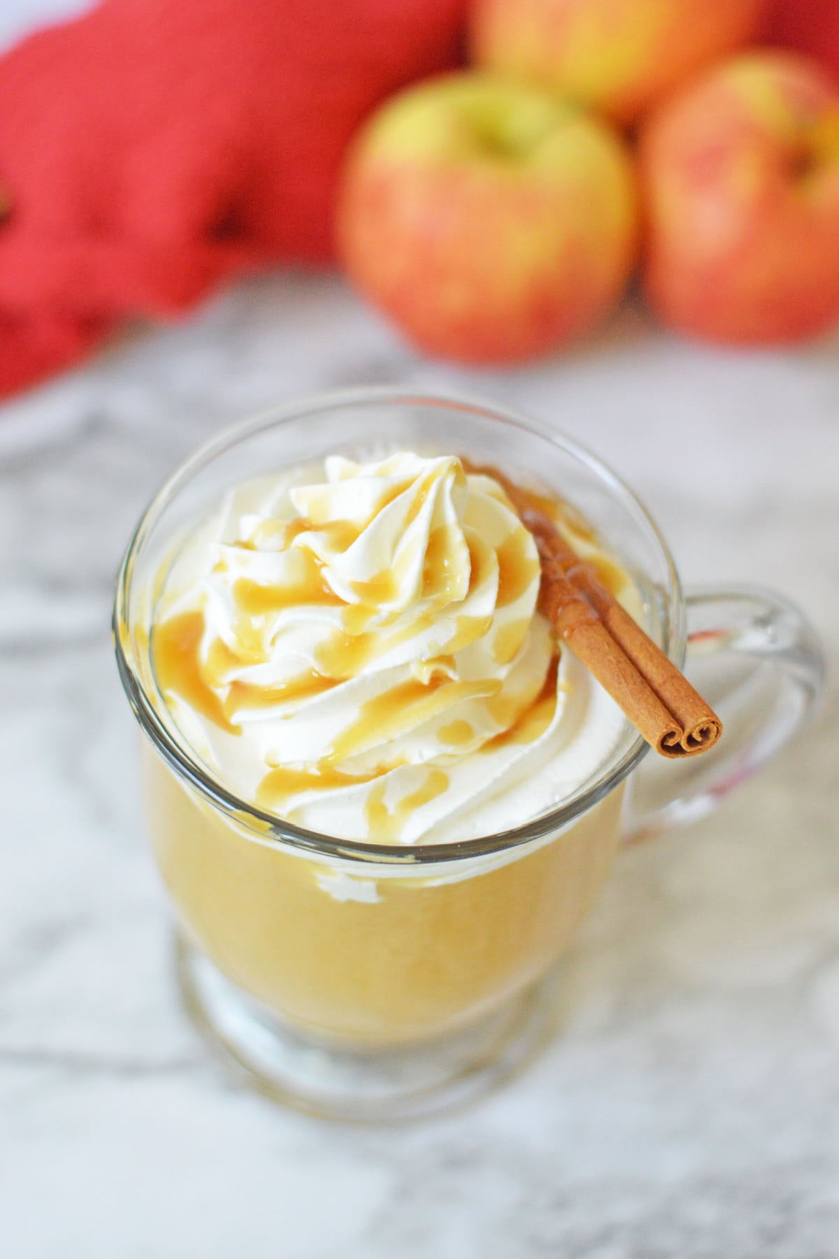 Hot Caramel Apple Cider with whipped cream and cinnamon stick