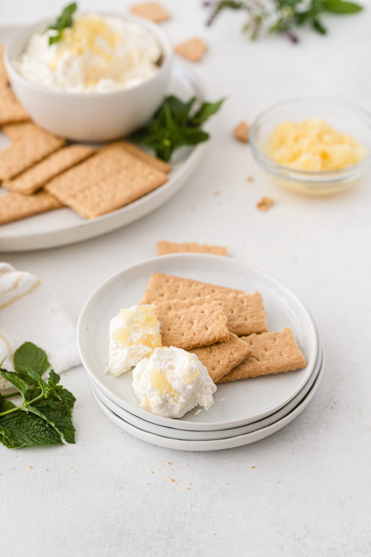 Pineapple cream cheese fluff on plate with graham crackers