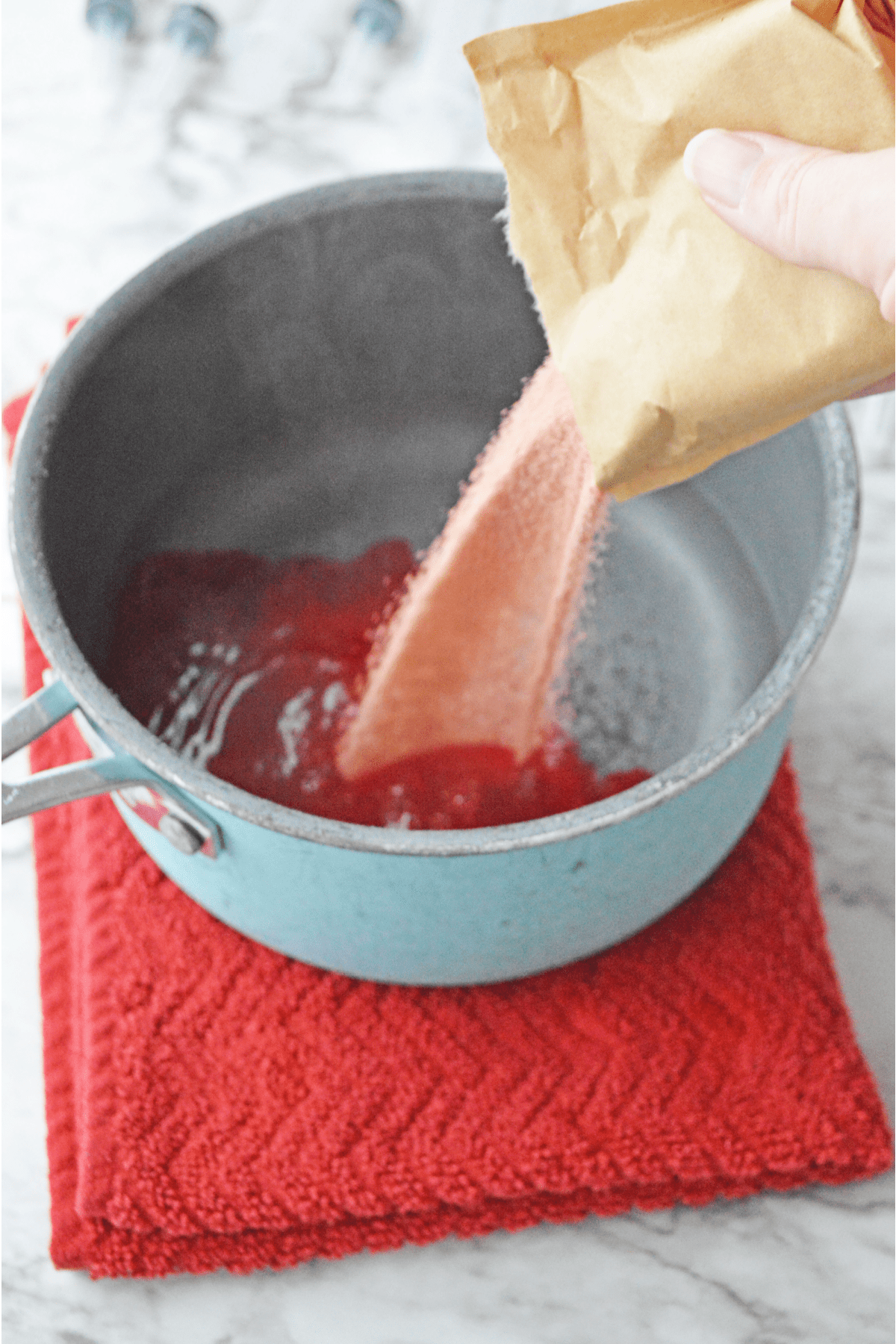 Pouring cherry jello into hot water