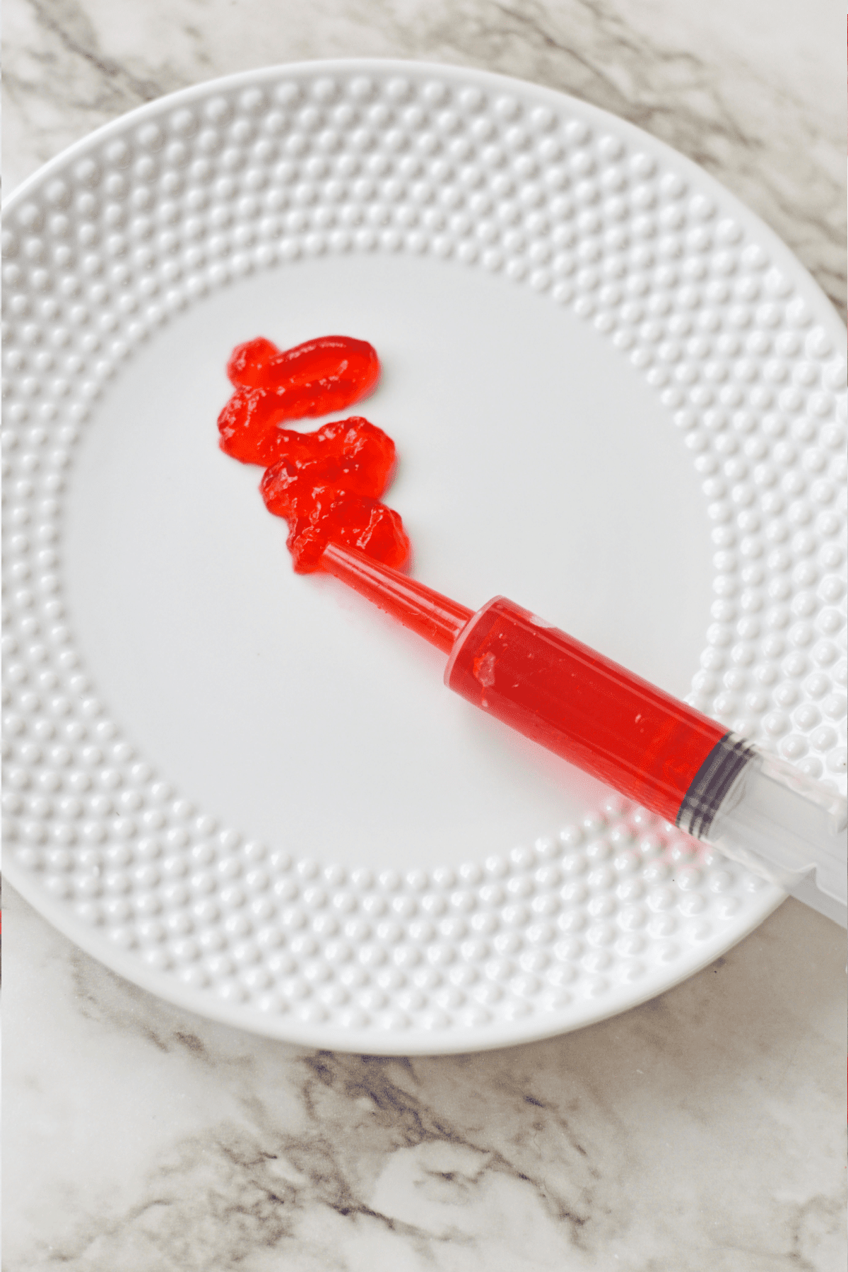 Red jello from jello shot syringe