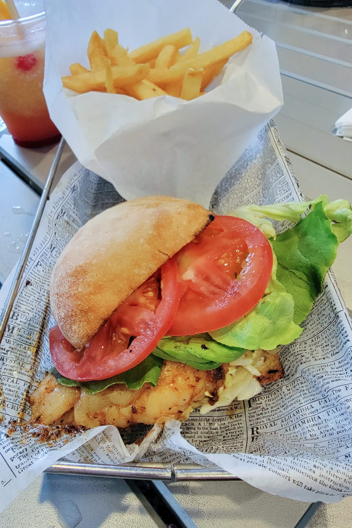 Chicken sandwich with tomatoes and fries
