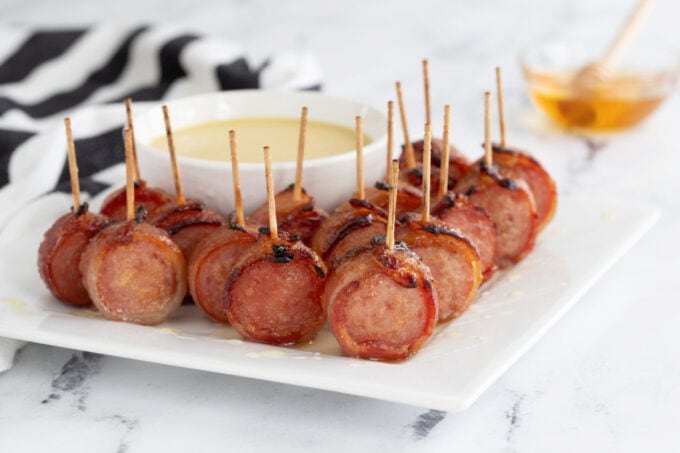 Bacon wrapped sausage with black and white napkin