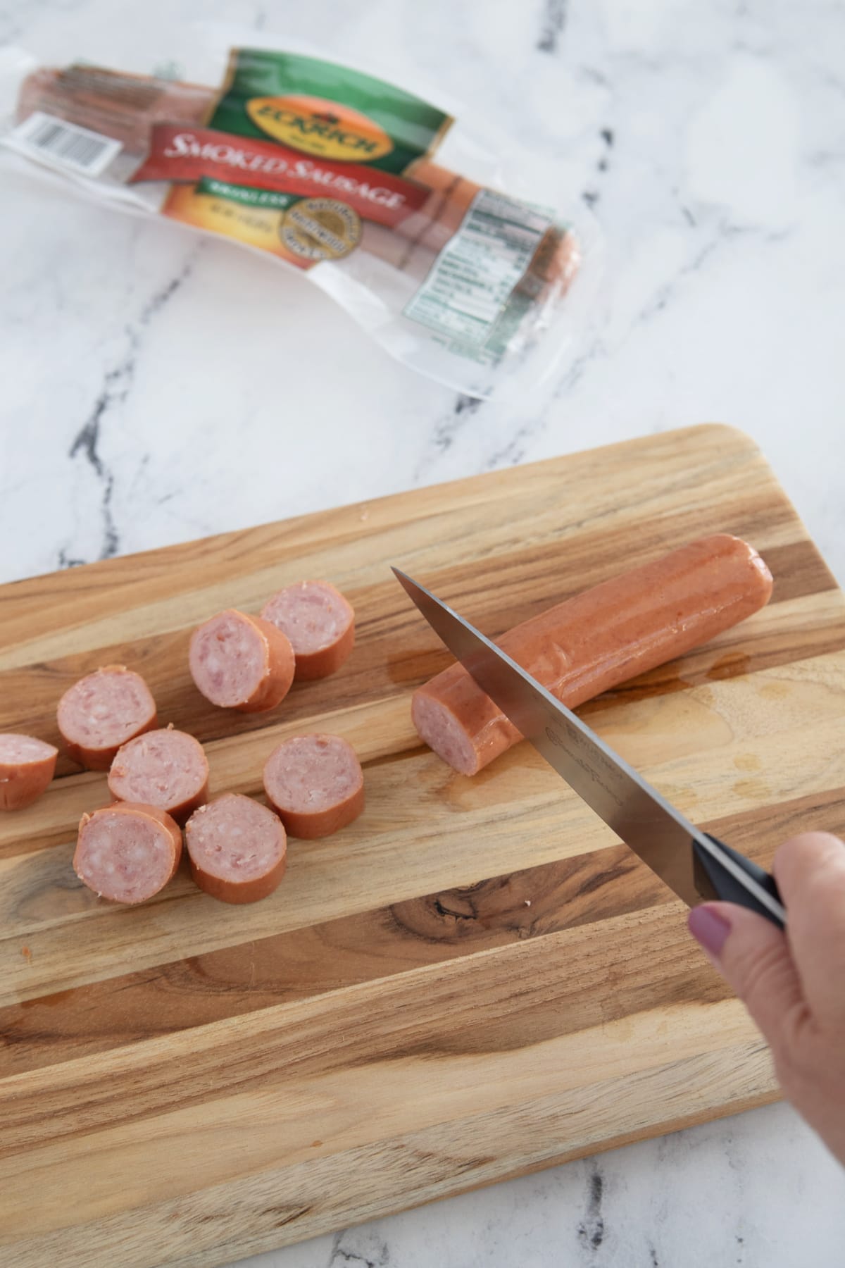 Slicing sausage on cutting board