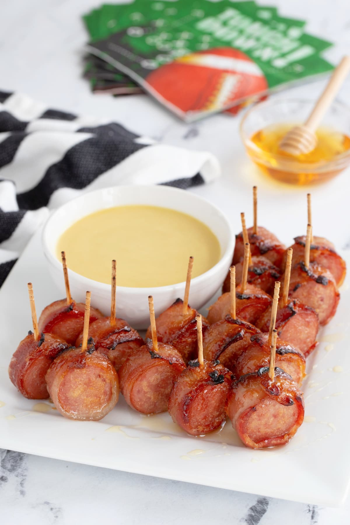 Bacon sausage appetizers with game day napkins in background