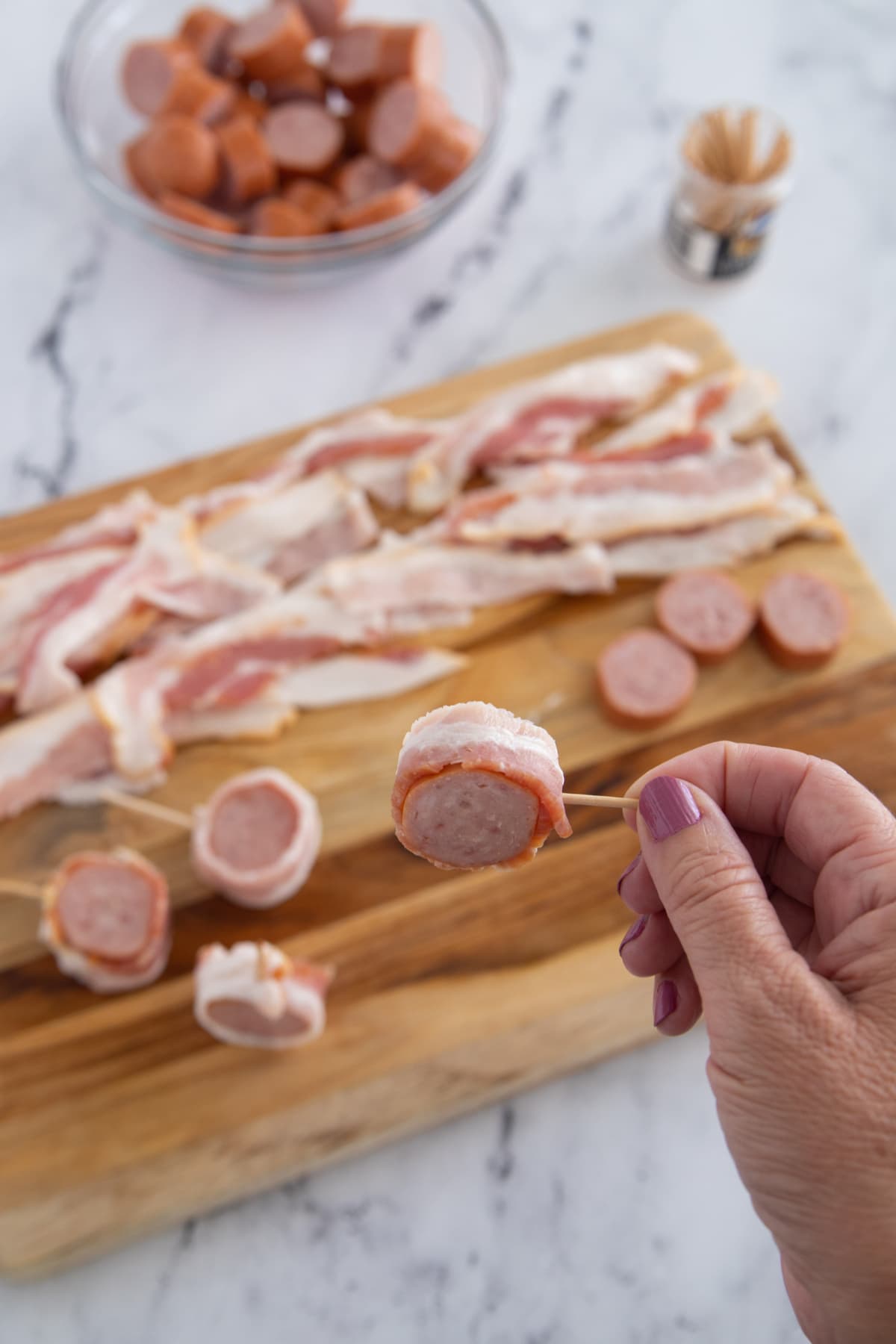 Bacon wrapped around sausage slice
