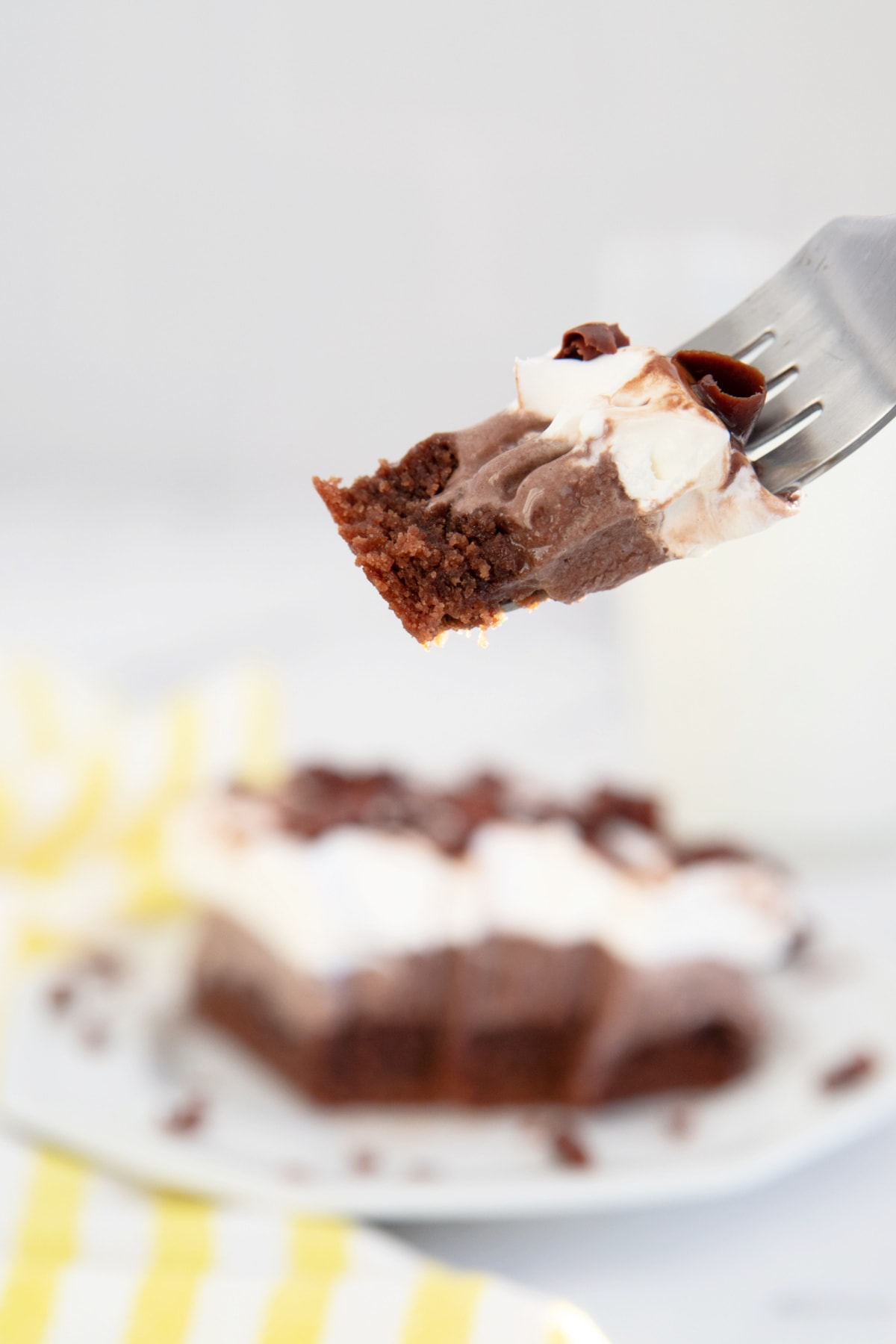 Bite of brownie ice cream cake on fork