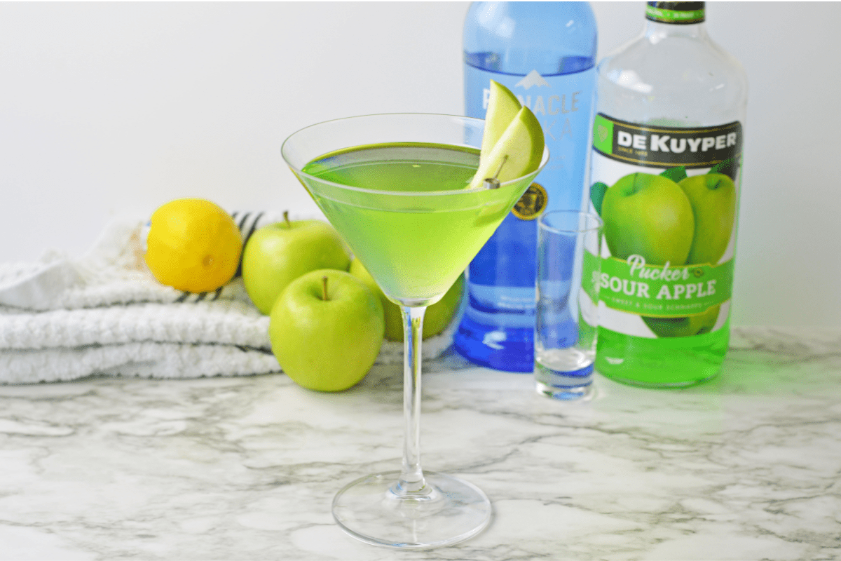 Apple martini with liquor bottles